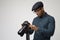 Studio Portrait Of Male Photographer With Camera