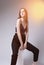 Studio Portrait of Sensual Caucasian Female Posing on White Prop with Light Flares