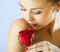 Studio portrait of sensual woman with rose