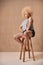 Studio Portrait Shot Of Body Positive Albino Woman Sitting On Stool