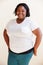 Studio Portrait Of Smiling Overweight Woman