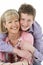 Studio Portrait of Smiling Teenage Boy with Mum