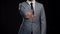 Studio portrait of successful and smart businessman in suit and tie. Man in formal wear over black background.