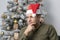 Studio portrait of a thoughtful man of oriental appearance 30-35 years old near a decorated Christmas tree.