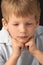 Studio Portrait Of Thoughtful Young Boy