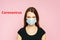 Studio portrait of woman wearing face medical mask, looking at camera, isolated on pink background, close up. Flu epidemic, dust a