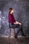 Studio portrait of young beautiful woman in a leather skirt