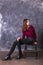 Studio portrait of young beautiful woman in a leather skirt