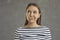 Studio portrait of young doubtful woman looking up thinking or planning