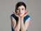 Studio portrait of young short hair beauty resting head on her open hands