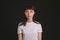 Studio portrait of a young woman against plain black background