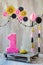 Studio scene for celebrating birthday of child one year old with fancy decor decorations on stylish wall