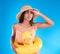 Studio, shocked woman on beach and vacation on blue background, looking or search with hat and hand on face. Travel