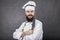 Studio shot of a bearded chef holding a big sharp knife