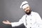 Studio shot of a bearded chef invinting you in