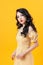 Studio shot of blithesome girl isolated on yellow background