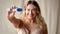 Studio Shot Of Body Positive Woman In Underwear Holding Positive Pregnancy Test