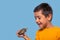 Studio shot of a boy holding a turtle in his hand on a blue background