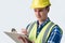 Studio Shot Of Builder Architect With Clipboard Against White Background