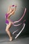Studio shot of curved gymnast dancing with ribbon