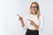 Studio shot of excited happy and overwhelmed young female student in elegant outfit glasses smiling thrilled