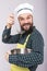 Studio shot of an expressive chef with beard tasting soup with