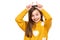 Studio shot of expressive cute child holding fingers behind head like bunny ears or horns, looking at camera and smiling.