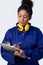 Studio Shot Of Female Engineer With Clipboard And Spanner Against White Background