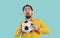 Studio shot of funny shy guy in shirt holding soccer ball with scared face expression