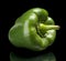 Studio shot of green bell pepper isolated black background