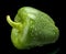 Studio shot of green bell pepper isolated on black with water dr