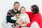 Studio shot of happy family of three family members and dog, embrace and smile happily, have good relationships, isolated on whit