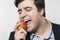 Studio shot of happy person eating an apple