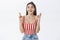 Studio shot of hopeful optimistic attractive caucasian brunette in striped top and headband smiling while feeling