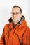 Studio shot of middle age man wearing orange jacket