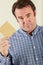 Studio Shot Of Middle Aged Man Holding Wage Packet