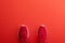 A studio shot of pair of running shoes on red background. Flat lay.