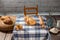 Studio shot of a scene from a room in a rural house. with a table with a retro checkered tablecloth, with flour, bread, muffins