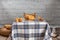 Studio shot of a scene from a room in a rural house. with a table with a retro checkered tablecloth, with flour, bread, muffins