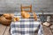 Studio shot of a scene from a room in a rural house. with a table with a retro checkered tablecloth, with flour, bread, muffins