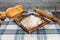 Studio shot of a scene from a room in a rural house. with a table with a retro checkered tablecloth, with flour, bread, muffins