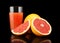 Studio shot sliced three grapefruits with juice isolated black