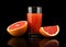 Studio shot sliced three grapefruits with juice isolated black