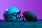 Studio shot of sportive professional equipment for american football game isolated over purple background in neon lights
