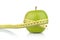 Studio shot of whole green healthy apple with tape measure