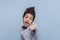 Studio shot of a young boy  reading to fend for himself, his fist is ready for battle on against blue background  with copy space