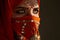 Studio shot of a young charming woman wearing the terracotta hijab decorated with sequins and jewelry. Arabic style.