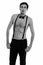 Studio shot of young handsome man standing with hands on pockets while wearing suspenders and bow tie shirtless