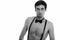 Studio shot of young handsome man wearing suspenders and bow tie shirtless
