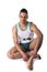Studio shot of young man in basketball tank-top sitting on floor